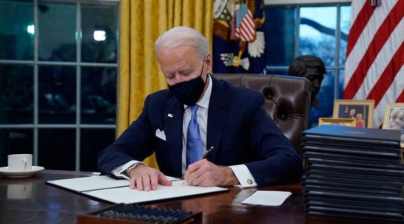 President Biden signs executive orders in the Oval Office